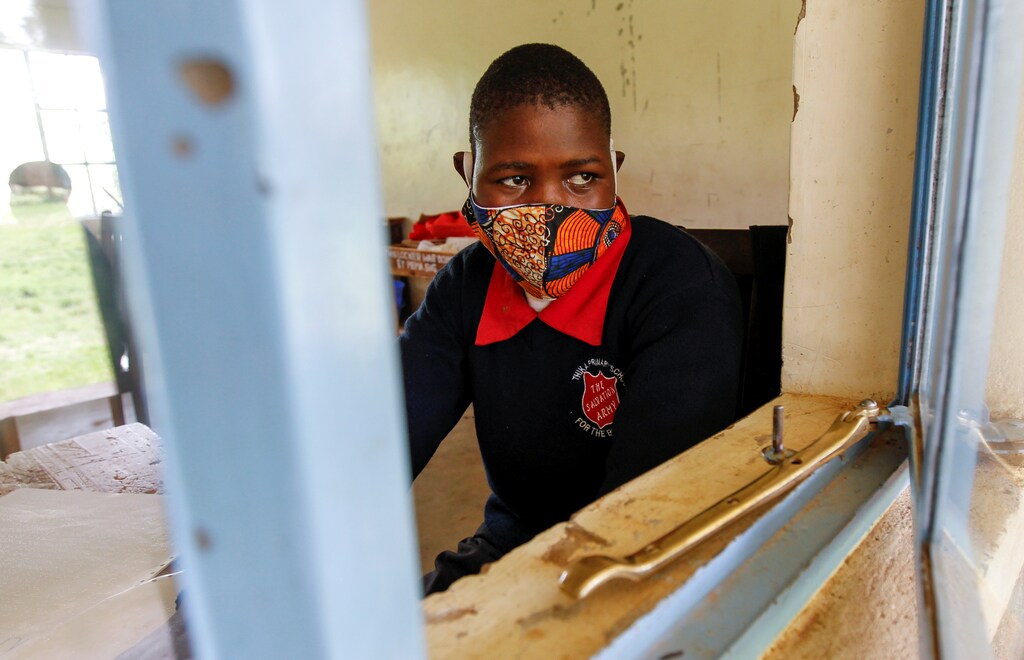 A Kenyan pupil attends a lesson, wearing a protective mask amid the spread of the coronavirus disease.