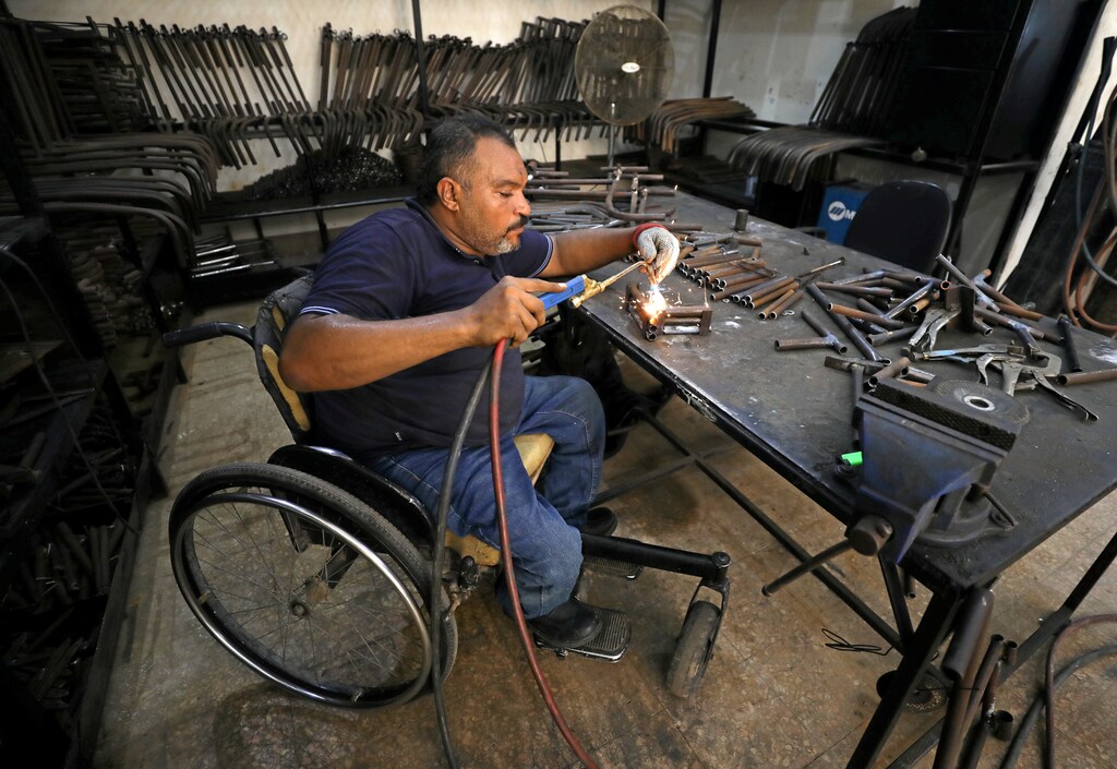A disabled Egyptian man works in a workshop that manufactures products for the poor disabled in Cairo, Egypt August 8, 2017. Picture taken August 8, 2017. REUTERS/Mohamed Abd El Ghany - RC141769AFE0