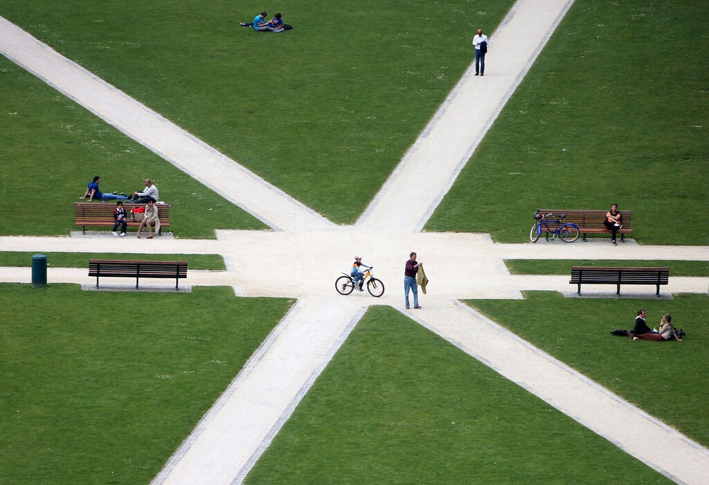 People sit in an urban park enjoying themselves.