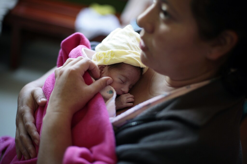 Alba Albisurez hugs her baby, who was born at 7 months, during the "Kangaroo Mothers" program in the maternity ward of the Roosevelt hospital in Guatemala City October 29, 2012. The 19-day program, known as "Madres Canguro", is a method where mothers are trained to breastfeed and hold their premature babies near their chest as the body-to-body contact reduces infant mortality in preterm infants. Over 300 women take part in the program every month, according to hospital authorities. It was first designed and implemented in Bogota, Colombia in 1978 and at the hospital since 1989. REUTERS/Jorge Dan Lopez (GUATEMALA - Tags: HEALTH) - RTR39R9F