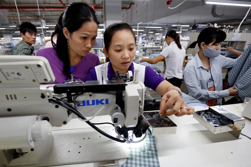 Seamstresses work at TAL garment factory in Vinh Phuc province, Vietnam May 23, 2017. Picture taken May 23, 2017. REUTERS/Kham - RC1E5C295DD0