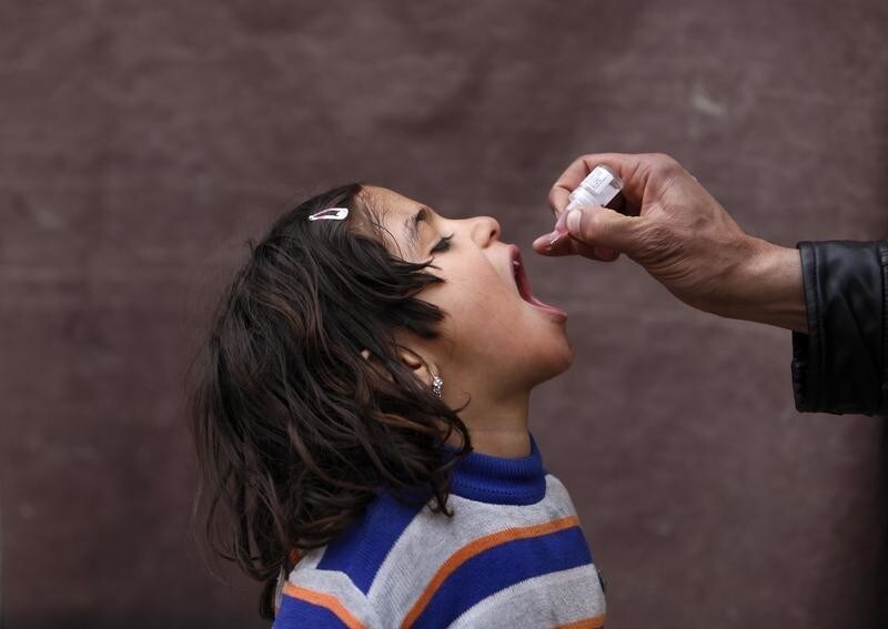 An Afghan child receives polio vaccination drops during an anti-polio campaign in Kabul March 24, 2014. REUTERS/Mohammad Ismail