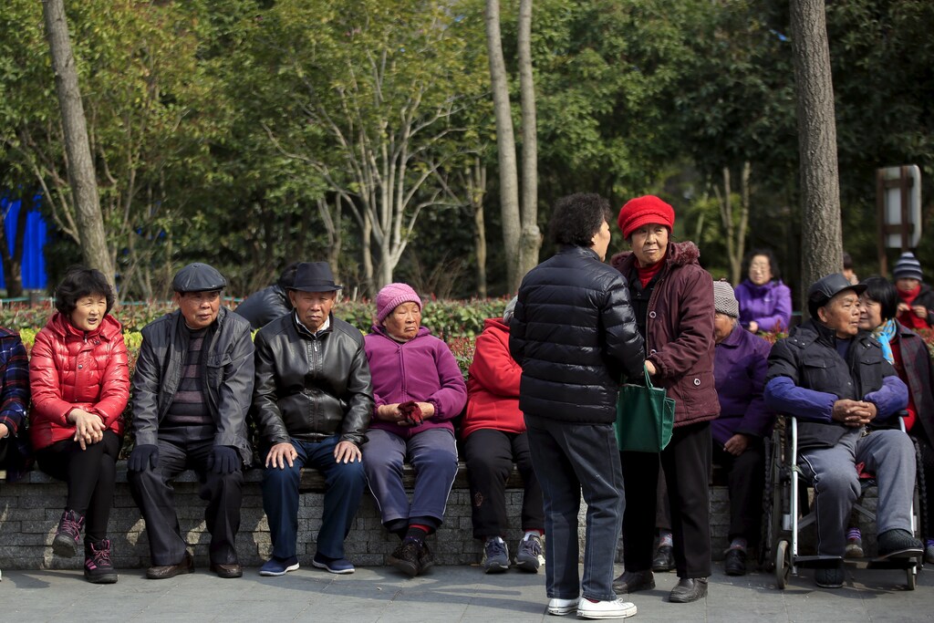 Elderly people enjoy the sunshine at an old residential site in Shanghai, China, March 14, 2016. REUTERS/Aly Song - GF10000344792