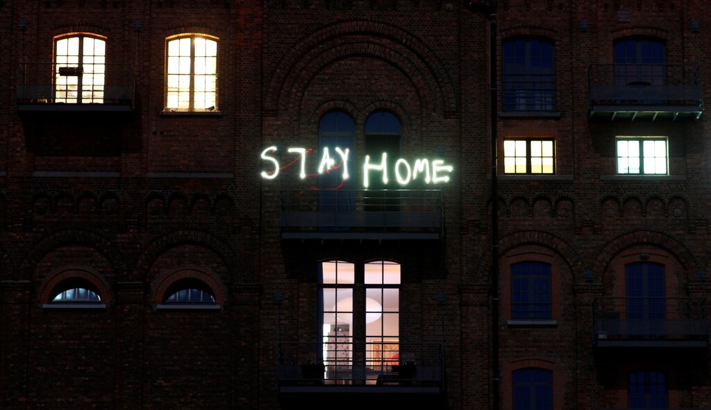 Residents write words "stay home" with their mobile phones as they stand on the balcony of their apartment block during the lockdown imposed by the Belgian government to slow down the coronavirus disease (COVID-19) spread, in Ruisbroek near Brussels, Belgium April 5, 2020. Picture taken with a long exposure. REUTERS/Francois Lenoir - RC2KYF9OLGND