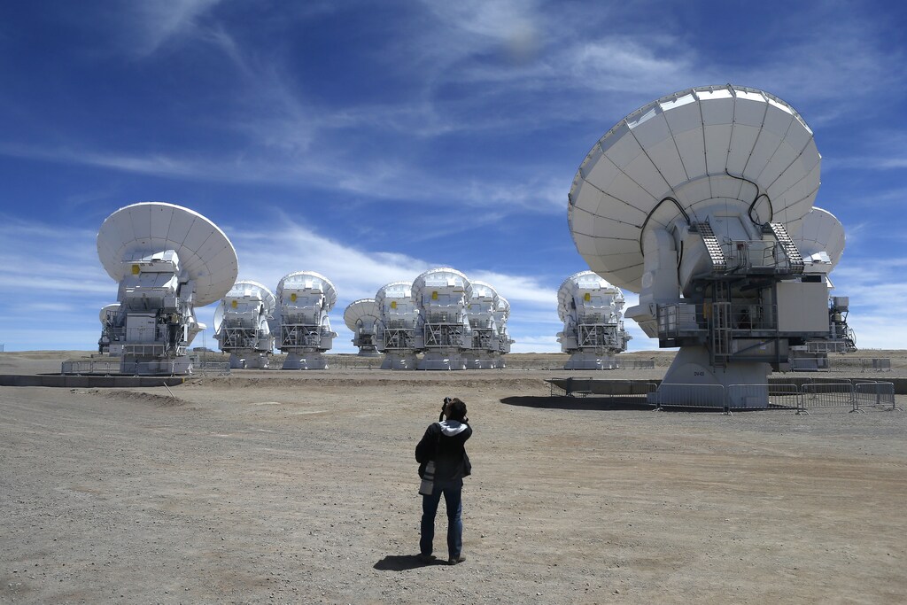 A member of the media takes pictures of the parabolic antennas of the ALMA (Atacama Large Millimetre/Submillimetre Array) project at the El Llano de Chajnantor in the Atacama desert, some 1730 km (1074 miles) north of Santiago and 5000 metres above sea level, March 12, 2013.