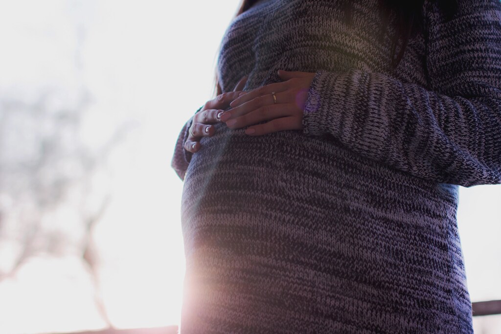 a picture of a woman resting her hands on her stomach