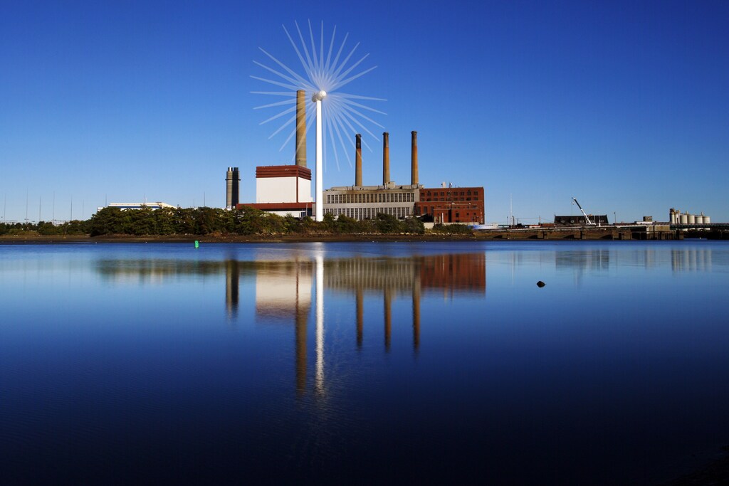 A Massachusetts Water Resources Authority wind turbine turns in front of a 1951 megawatt fossil fuel power plant in Charlestown, Massachusetts September 18, 2013. The wind turbine powers the MWRA waste water pumping station at that site and the power plant uses natural gas and oil. The Intergovernmental Panel on Climate Change conference will be held in Stockholm September 23 to 26. This is an in-camera, multiple exposure photograph. REUTERS/Brian Snyder (UNITED STATES - Tags: ENVIRONMENT ENERGY) - GM1E99J0JII01