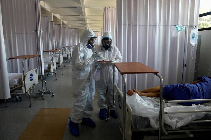 Medical staff are seen looking after a patient inside the provisional military hospital of the Campo Militar No. 1, which takes care of patients with symptoms of the coronavirus disease (COVID-19) in Mexico City, Mexico June 9, 2020. Picture taken June 9, 2020.REUTERS/Carlos Jasso