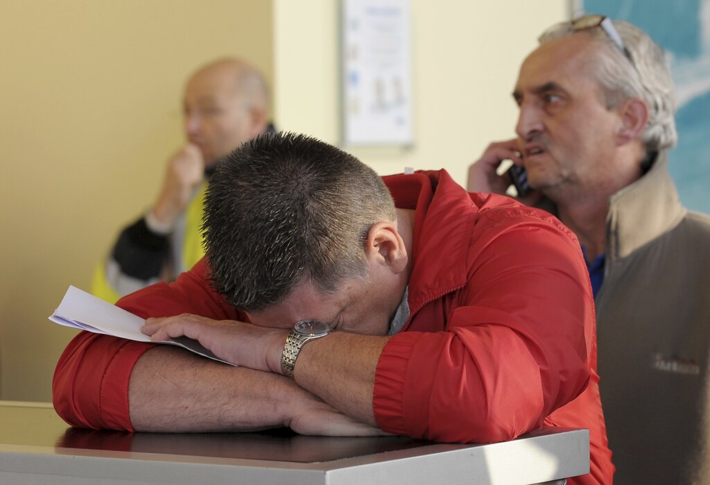 A worker at a Ford assembly plant reacts after an emergency meeting with the plant management in Genk October 24, 2012. Ford Motor Co announced to unions on Wednesday that it will close the factory employing 4,300 workers in the Belgian town of Genk, as it tries to stem losses in Europe and match capacity to tumbling demand. REUTERS/Laurent Dubrule (BELGIUM - Tags: TRANSPORT BUSINESS EMPLOYMENT) - GM1E8AO1BR901