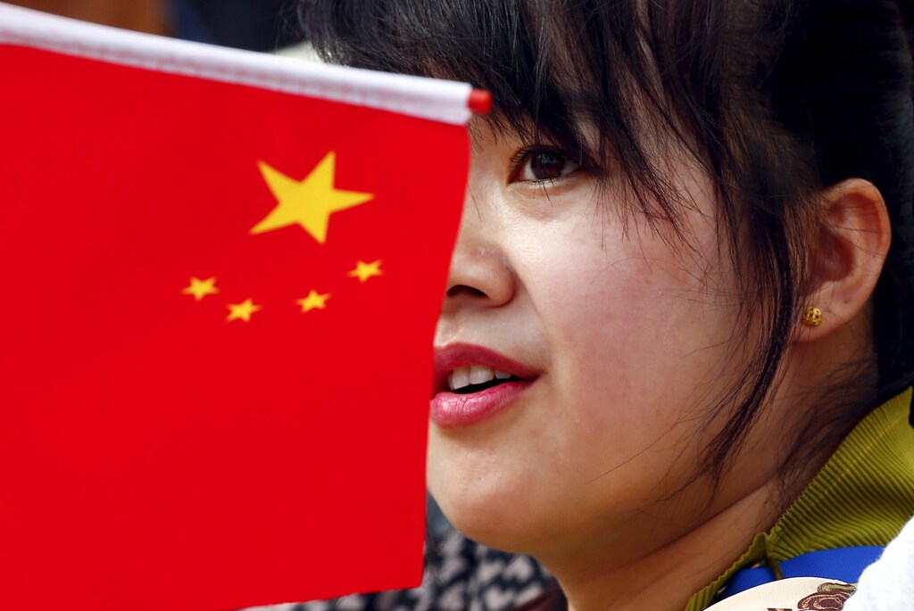 A Chinese faithful looks on as Pope Francis arrives to lead the weekly audience is Saint Peter's Square at the Vatican September 16, 2015. REUTERS/Tony Gentile - RTS1BJQ