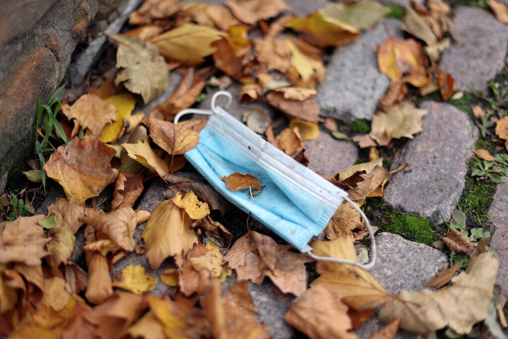 A protective face mask is pictured on a street, following the outbreak of the coronavirus disease (COVID-19), in Nottingham, Britain October 12, 2020. REUTERS/Carl Recine - RC21HJ959M4W