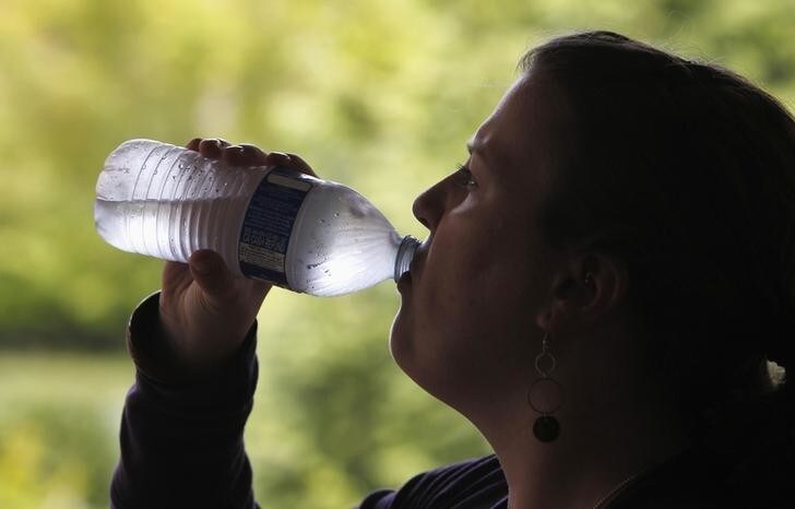 A woman drinks from a water bottle in Portland, Oregon May 23, 2014. Some 670,000 residents in Portland, Oregon, and nearby suburbs were instructed to boil their water before drinking it because of possible fecal contamination, the city's Water Bureausaid on Friday. REUTERS/Steve Dipaola (UNITED STATES - Tags: ENVIRONMENT HEALTH FOOD)