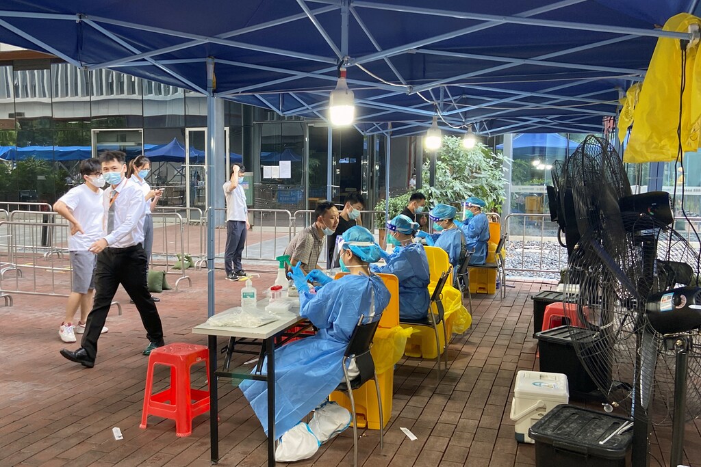 Medical workers in protective suits collect swabs in Nanshan district, following the COVID-19 outbreak in Shenzhen, Guangdong province, China