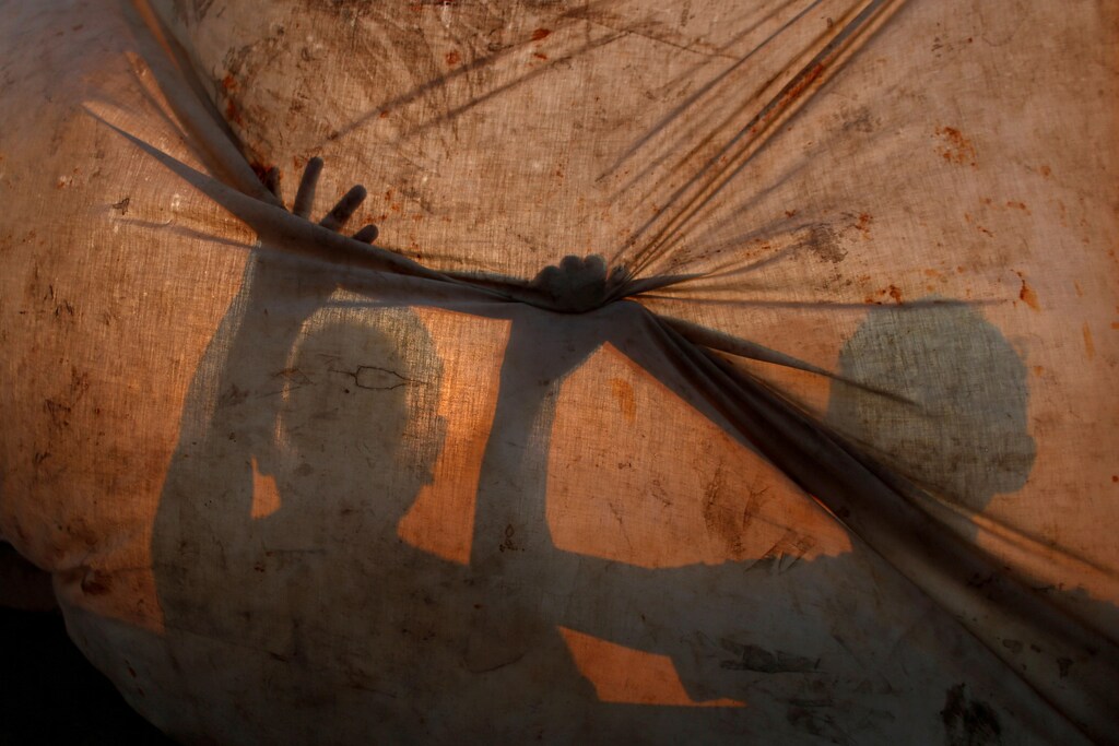 Palestinian fishermen repair their net at Al-Shati refugee camp in Gaza City September 16, 2019.