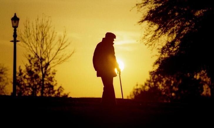 An elderly man makes his way down Primrose Hill in London as the sun sets November 12. As the approaching Winter shortens daylight in Britain, many were out in the park making the most of the remaining daylight on a crisp and clear day.BRITAIN WEATHER
