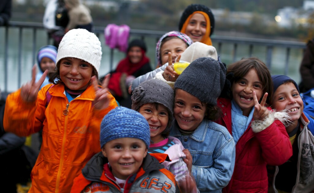 Migrant children pose before passing the Austrian-German border.
