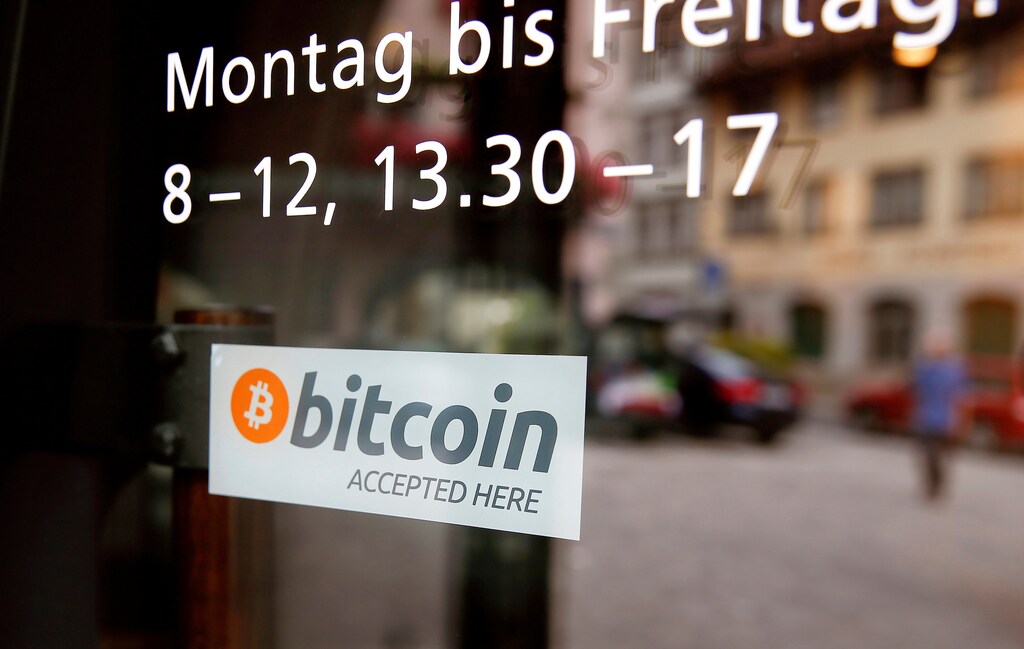 A sticker that reads "Bitcoin accepted here" is displayed at the entrance of the Stadthaus town hall in Zug, Switzerland, August 30, 2016. Picture taken August 30, 2016. REUTERS/Arnd Wiegmann - RTX2OLTJ