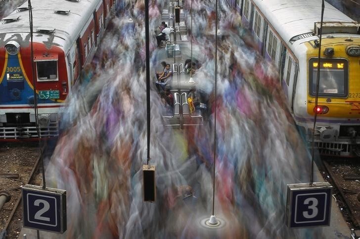 Commuters disembark from crowded suburban trains during the morning rush hour at Churchgate railway station on World Population Day in Mumbai July 11, 2012.