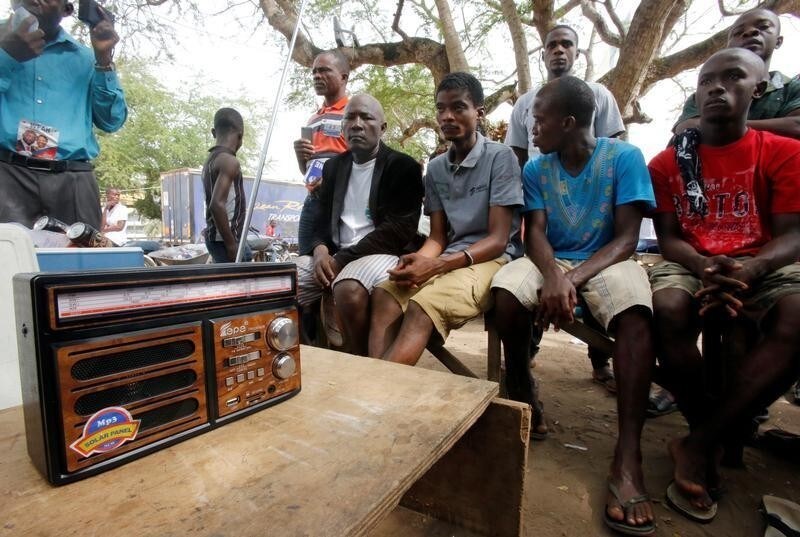 Supporters of George Weah, former soccer player and presidential candidate of Coalition for Democratic Change (CDC), listen to the announcement of the presidential election results on the radio, in Monrovia, Liberia December 27, 2017. REUTERS/Thierry Gouegnon - RC15DD635580