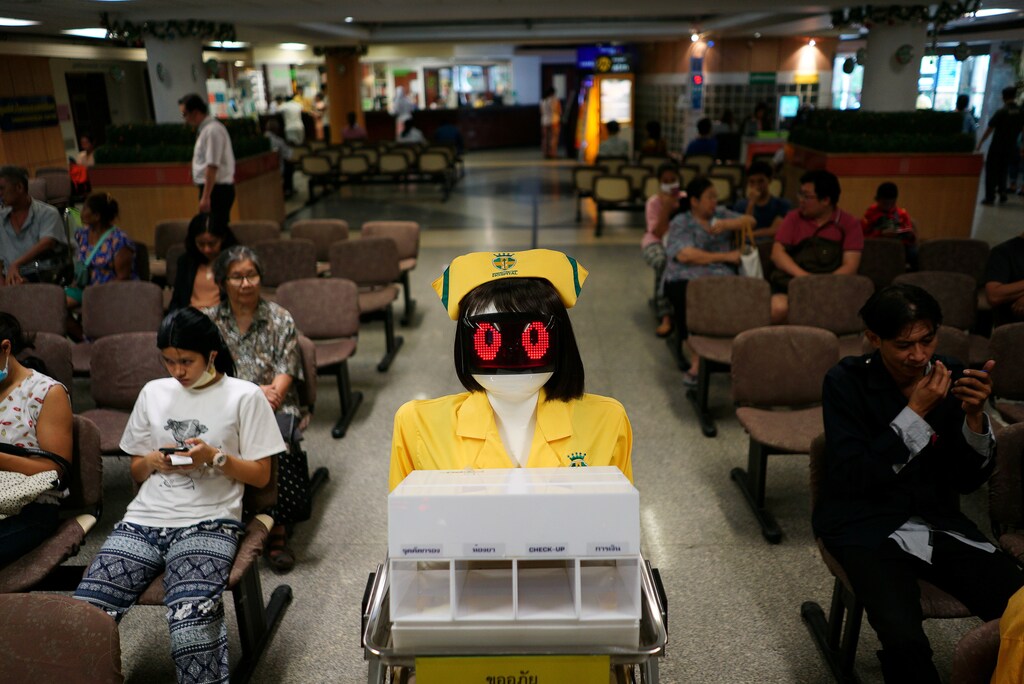 A robot wearing a nurse costume carries medical documents at Mongkutwattana General Hospital in Bangkok, Thailand, February 6, 2019. REUTERS/Athit Perawongmetha - RC1B01E87750