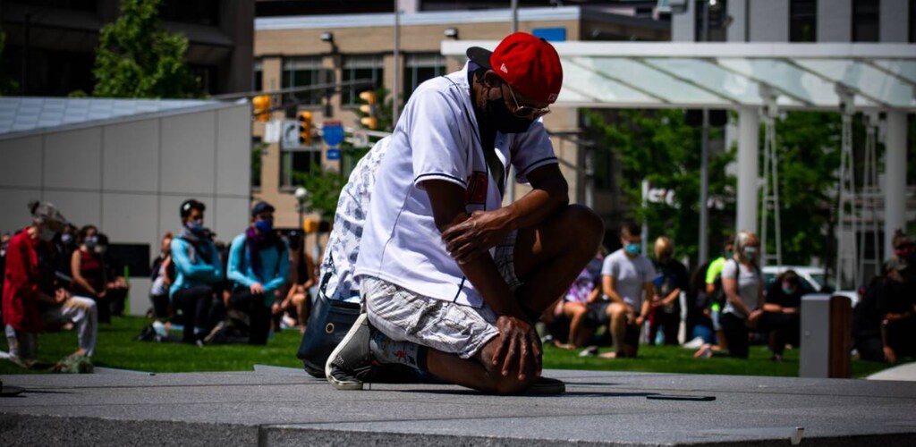 Chris Shelton kneels during a demonstration in downtown Indianapolis, United States. Veronica Holford