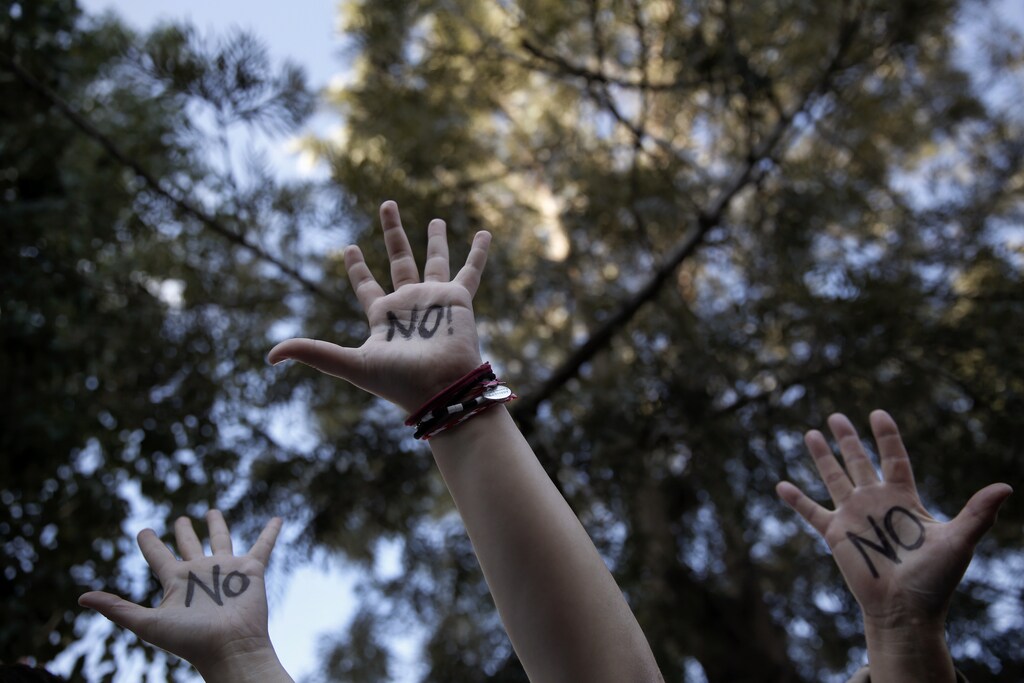 Protesters raise their open palms showing the world "No" during an anti-bailout rally outside the parliament in Nicosia March 18, 2013. Cypriot ministers were trying to revise a plan to seize money from bank deposits before a parliamentary vote on Tuesday that will secure the island's financial rescue or could lead to its default, with reverberations across the euro zone. REUTERS/Yorgos Karahalis (CYPRUS - Tags: POLITICS CIVIL UNREST BUSINESS TPX IMAGES OF THE DAY) - RTR3F5NJ