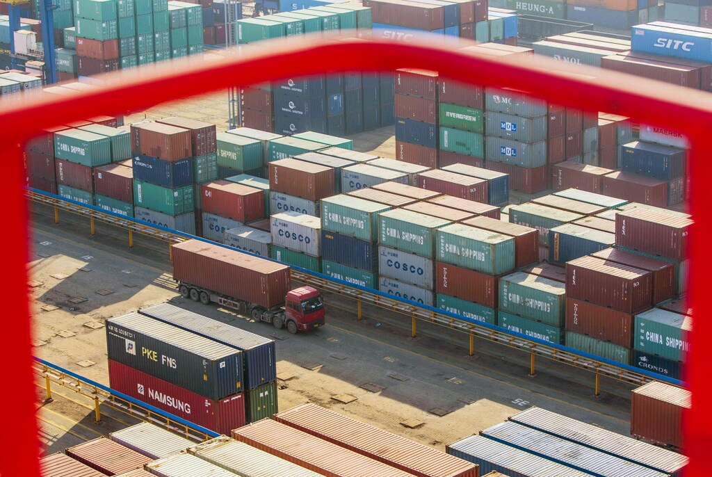 A truck drives past shipping containers at a port in Lianyungang, China. Disruptions to the global trade status quo have created vulnerabilities for criminals to exploit.