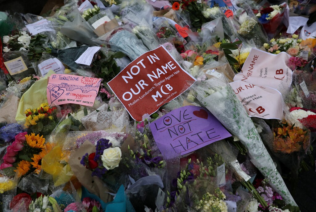 Floral tributes lie on the ground after a vigil to remember the victims of the attack on London Bridge and Borough Market, at Potters Field Park, in central London, Britain, June 5, 2017. REUTERS/Marko Djurica - RTX395SM