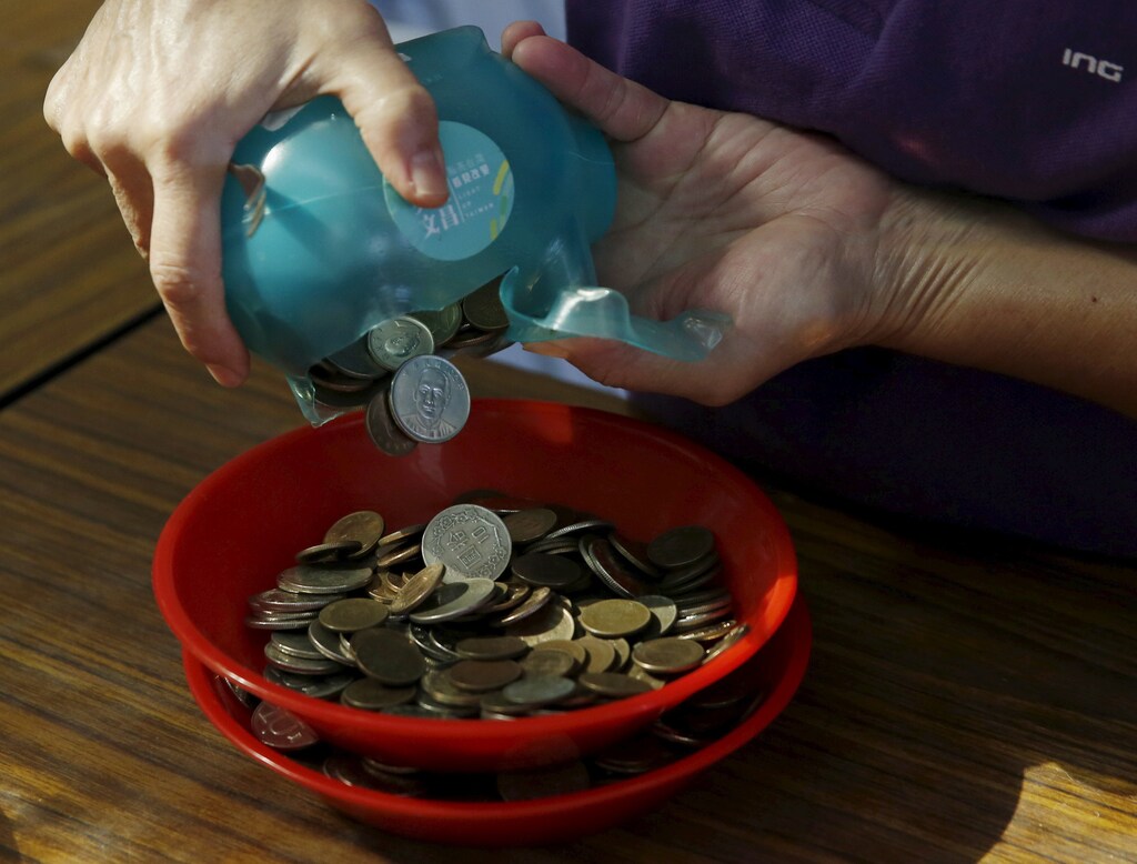 Donations collected from piggy banks for Taiwan's Democratic Progressive Party (DPP) campaign fund are counted at the party headquarters in Taipei, Taiwan, January 9, 2016. REUTERS/Olivia Harris - RTX21LT4