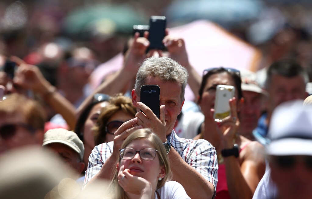 People take pictures with their cell phones in Saint Peter's Square at the Vatican, July 2, 2017. REUTERS/Alessandro Bianchi - RC1889631EB0