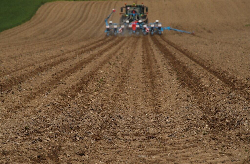 A tractor sows seeds in a field in Lavigny, Switzerland May 1, 2019. REUTERS/Denis Balibouse - RC19F10E5B90