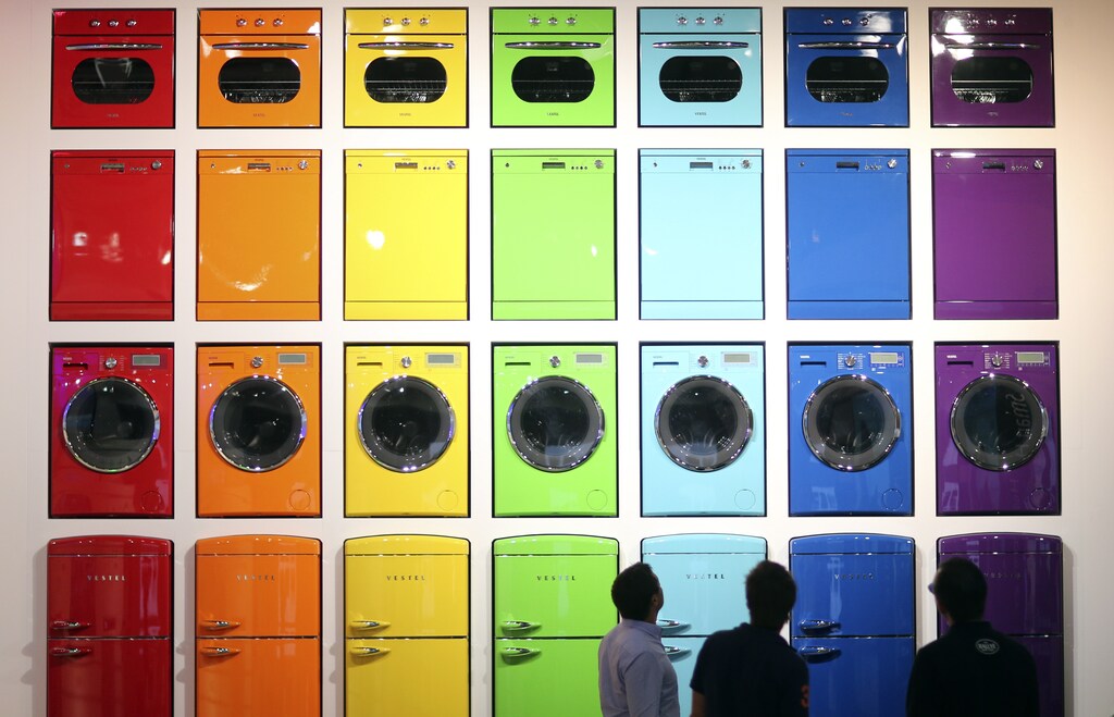 Visitors look at a display of stoves, dishwashers, washing machines and integrated fridge freezers (from top to bottom) produced by Vestel during the IFA Electronics show in Berlin September 4, 2014. REUTERS/Hannibal Hanschke (GERMANY - Tags: BUSINESS SCIENCE TECHNOLOGY) - LR1EA94112210