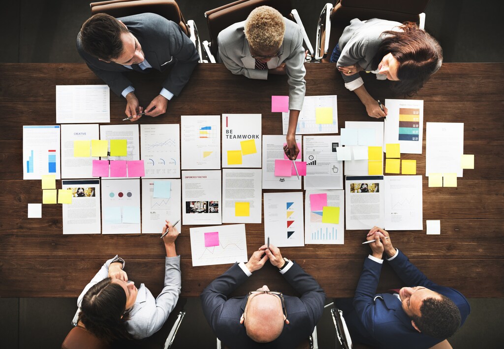 Business People Analyzing Statistics Financial Concept - genders working together