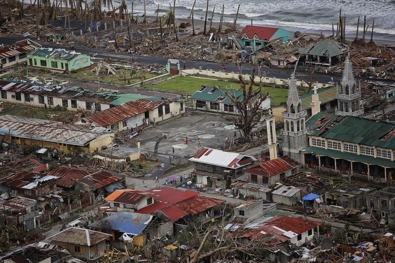 A coastal town destroyed by Typhoon Haiyan is seen from a military helicopter delivering aid north of Tacloban November 17, 2013. Mobbed by hungry villagers, U.S. military helicopters dropped desperately needed aid into remote areas of the typhoon-ravaged central Philippines, as survivors of the disaster flocked to ruined churches on Sunday to pray for their uncertain future. The Philippines is facing up to an enormous rebuilding task from Typhoon Haiyan, which killed at least 3,681 people and left 1,186 missing, with many isolated communities yet to receive significant aid despite a massive international relief effort.