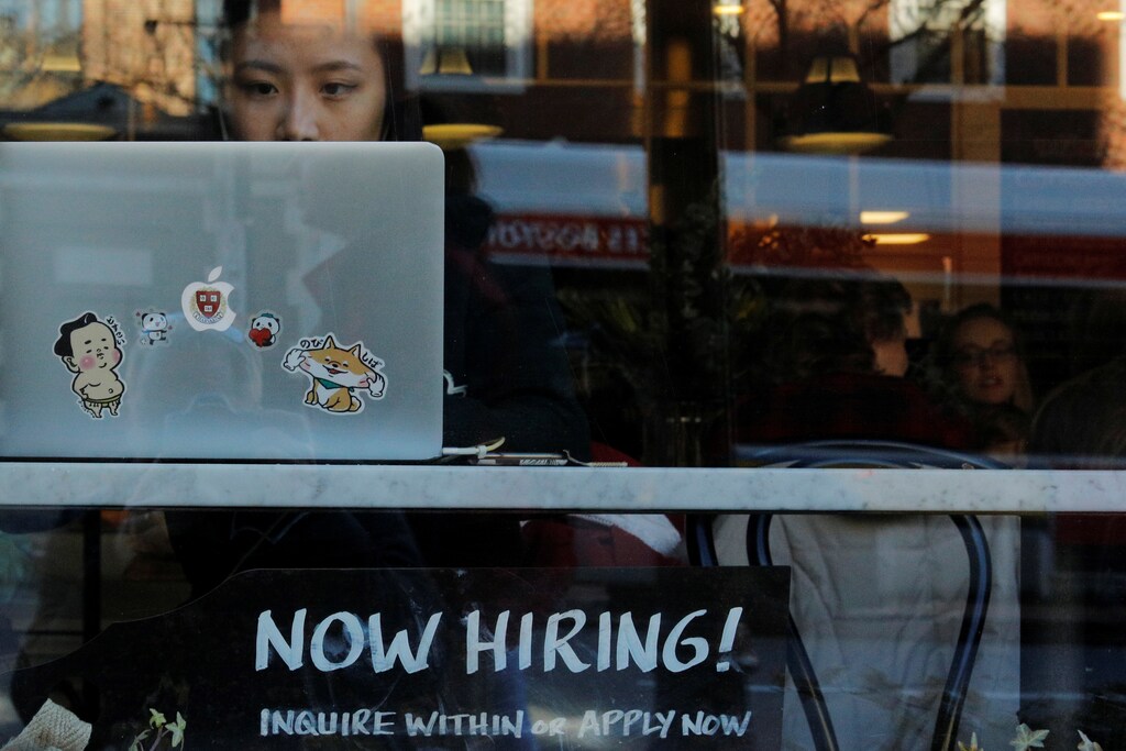 A "Now Hiring" sign sits in the window of Tatte Bakery and Cafe in Cambridge, Massachusetts, U.S., February 11, 2019. REUTERS/Brian Snyder - RC179706A2B0
