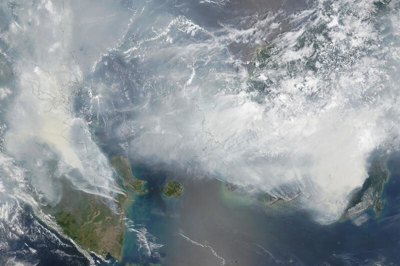 NASA satellite image seen in this September 24, 2015 image from the Moderate Resolution Imaging Spectroradiometer (MODIS) on NASA's Terra satellite shows smoke from fires in Indonesia over the coasts of Borneo and Sumatra. Red outlines indicate hot spots where the sensor detected unusually warm surface temperatures associated with fires. Thick gray smoke hovers over both islands and has triggered air quality alerts and health warnings in Indonesia and neighboring countries. Visibility has plummeted. REUTERS/NASA image by Adam Voiland (NASA Earth Observatory) and Jeff Schmaltz (LANCE MODIS Rapid Response)/Handout FOR EDITORIAL USE ONLY. NOT FOR SALE FOR MARKETING OR ADVERTISING CAMPAIGNS. THIS IMAGE HAS BEEN SUPPLIED BY A THIRD PARTY. IT IS DISTRIBUTED, EXACTLY AS RECEIVED BY REUTERS, AS A SERVICE TO CLIENTS TPX IMAGES OF THE DAY - GF10000229565