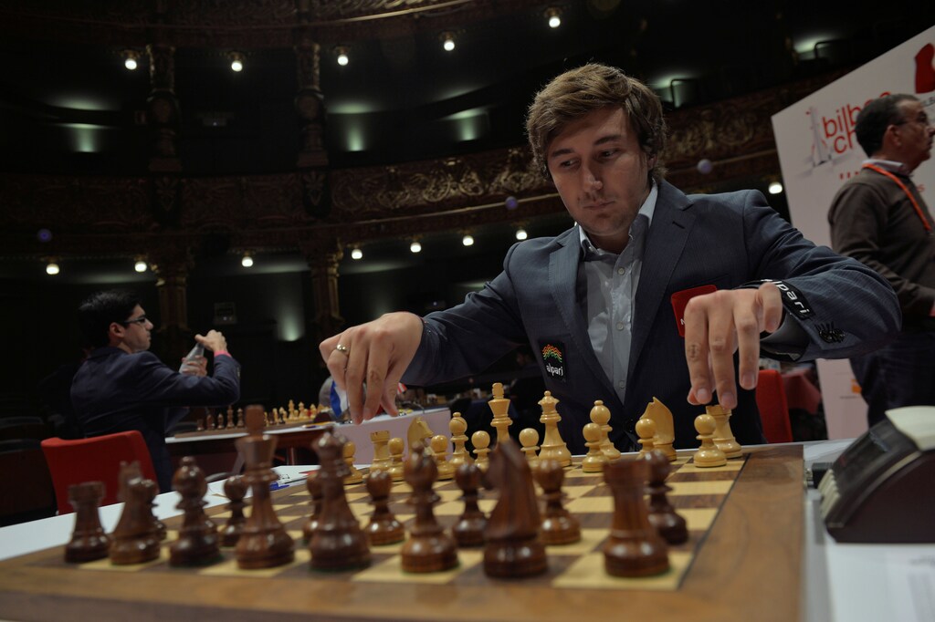 Russian grandmaster Sergey Karjakin adjusts his pieces before a game against Norwegian world chess champion Magnus Carlsen at the IX Chess Masters Final in Bilbao, northern Spain, July 21, 2016. REUTERS/Vincent West - D1BETQWGAGAB