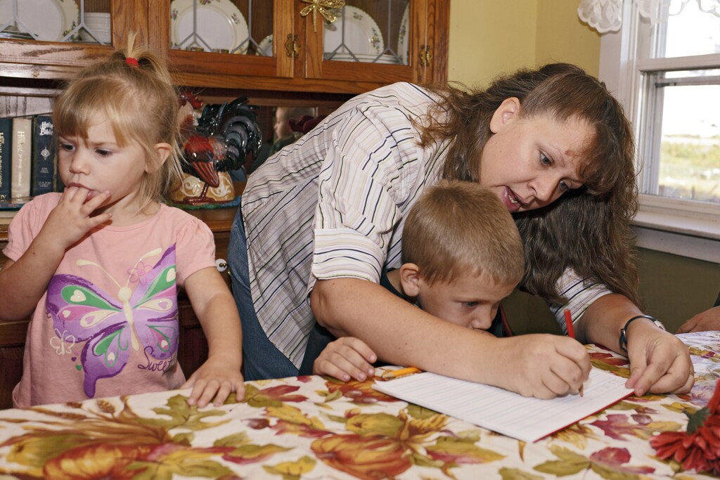 a mother tends to her two young children