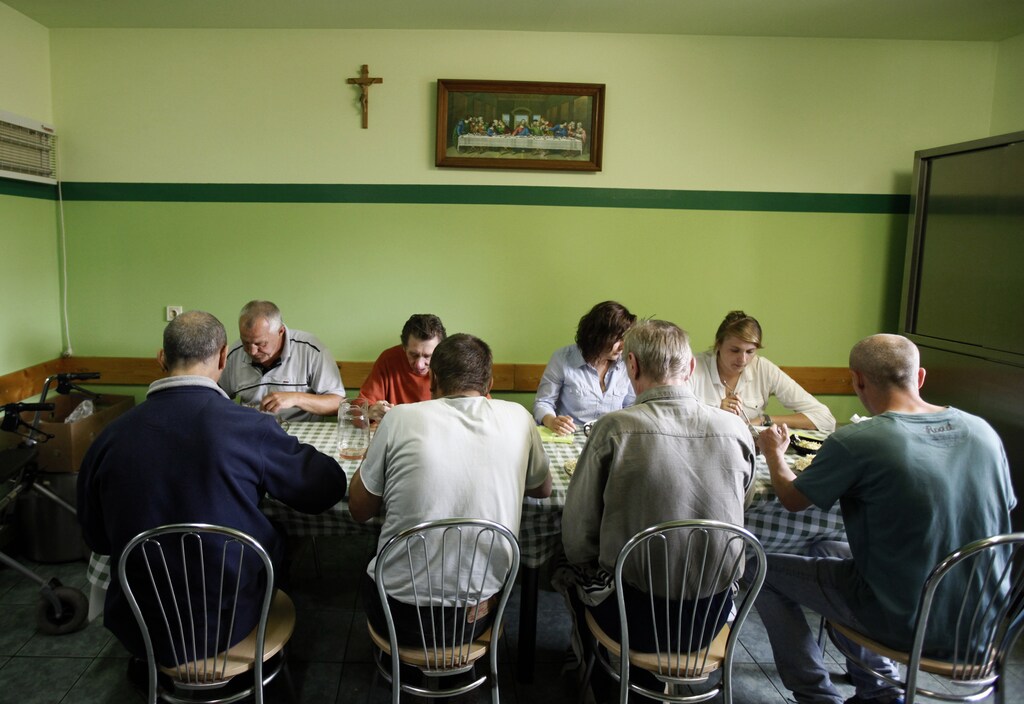 Residents eat a meal at the Camillian Mission shelter for homeless people in Warsaw June 4, 2013. Food Bank SOS is an organisation that distributes food, including produce that would have otherwise gone to waste, to charities such as the Camillian Mission, which use it to help the needy. Cutting the amount of food that goes to waste is the special theme of this year's World Environment Day on June 5. The U.N. Food and Agriculture Organisation estimates that about a third of all the food produced for human consumption worldwide every year is wasted. Picture taken June 4, 2013. REUTERS/Kacper Pempel (POLAND - Tags: ENVIRONMENT AGRICULTURE SOCIETY POVERTY)ATTENTION EDITORS: PICTURE 15 OF 19 FOR PACKAGE 'ENVIRONMENT DAY - FOOD BANK SOS' SEARCH 'FOOD BANK SOS' FOR ALL IMAGES - GM1E96516FI01