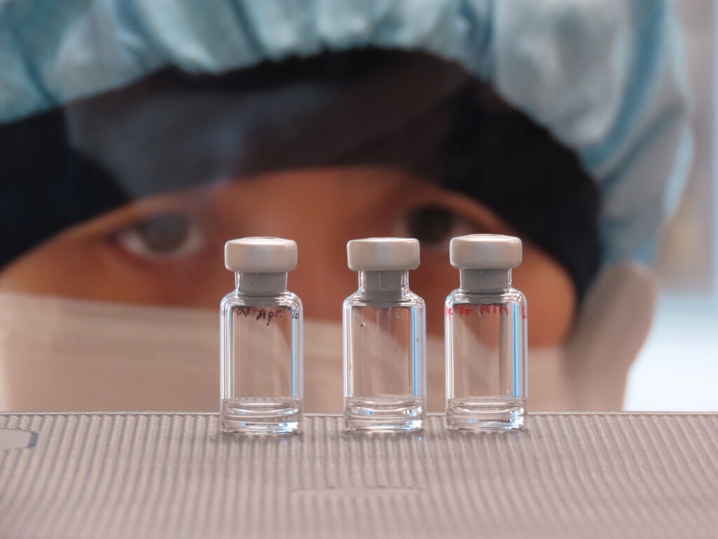 A scientist checks quality control of vaccine vials for correct volume at the Clinical Biomanufacturing Facility (CBF) in Oxford, Britain, April 2, 2020. Picture taken April 2, 2020.