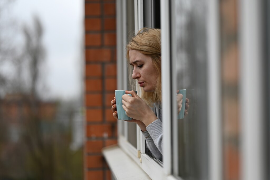 Evgenia Pivovarova drinks tea during self-isolation at home in the southern city of Rostov-on-Don, Russia March 30, 2020. Photographer Sergey Pivovarov and his wife Evgenia were on vacation in Spain when the coronavirus disease (COVID-19) outbreak started. After returning to Russia safely the couple had to spend two weeks self-isolated due to the rules imposed by the authorities. Sergey shares pictures taken inside the family apartment during this time. Picture taken March 30, 2020. REUTERS/Sergey Pivovarov - RC2KWF9G7RBU