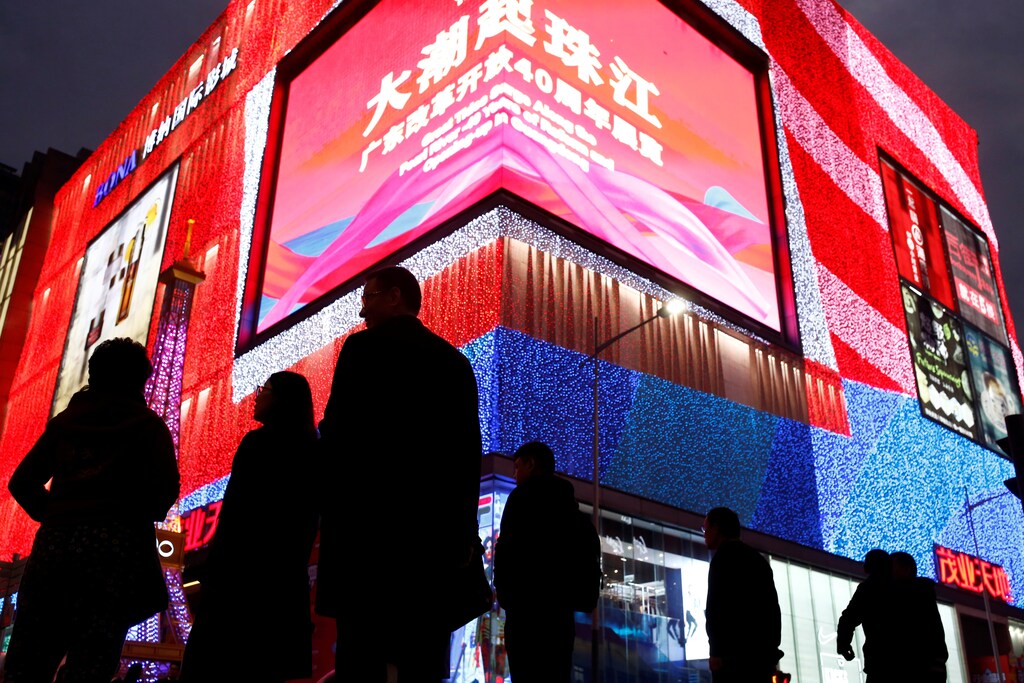 People walk in Huaqiangbei Commercial Street, a shopping district for electronics and market place for Chinese producers and international wholesale buyers, in Shenzhen, Guangdong Province, China, December 13, 2018. Picture taken December 13, 2018. REUTERS/Thomas Peter - RC1BD6801EB0