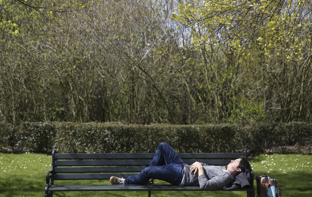 A man rests on a bench on a sunny day in Regent's Park in London, Britain April 17, 2016. REUTERS/Neil Hall - LR1EC4H14W7UY