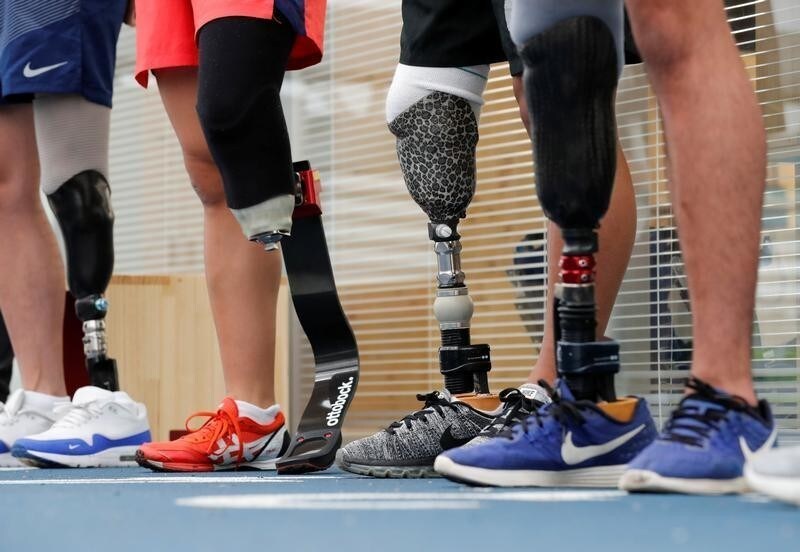 Participants wear prosthetics at an opening ceremony of a special "library" that lets people borrow and try out prosthetic "blades" for runners, in Tokyo, Japan, October 15, 2017. Picture taken October 15, 2017.