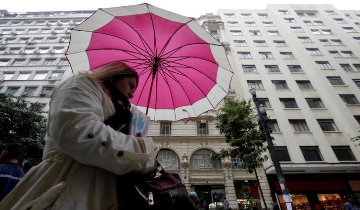 A woman walks on the street during the first day of the winter season in downtown Sao Paulo, Brazil June 21, 2017. REUTERS/Paulo Whitaker