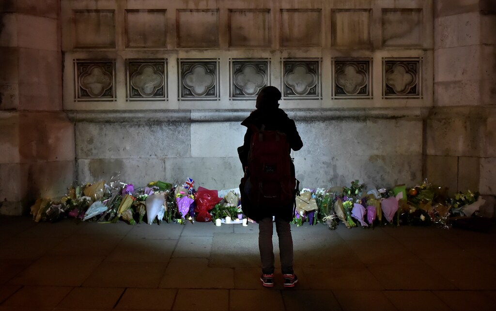 A woman looks at floral tributes laid in Westminster the day after a attack in London, Britain, March 23, 2017. REUTERS/Hannah McKay - RTX32GE6
