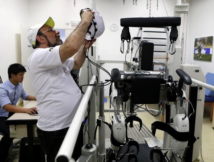 Brazilian neuroscientist Miguel Nicolelis works in his robotic laboratory in Sao Paulo May 21, 2014. Nicolelis is leading "The Walk Again Project", where a mechanical exoskeleton is able to support a paralysed person's lower body and responds to wireless commands that come from electrodes placed on the person's scalp or within the brain. The robotic exoskeleton could allow a paraplegic to deliver the first kick of the World Cup in Brazil next month, as part of a project to showcase technology aimed at overcoming paralysis. Picture taken May 21, 2014.