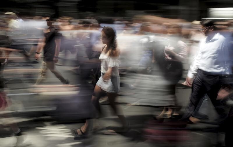 Pedestrians walk through Sydney's business district, February 16, 2016. Australia's official population clock this month ticked past 24 million, several years sooner than expected, thanks in part to a booming education industry drawing students from all over Asia.