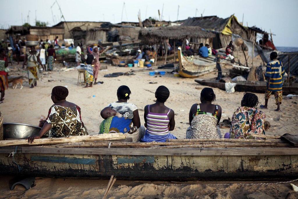 Women sit on a fishing boat in the Akpakpa neighbourhood of Benin's capital Cotonou