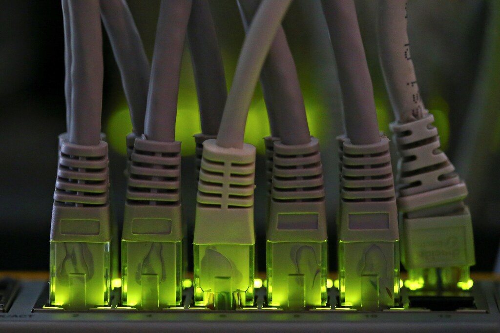 LAN network cables plugged into a Bitcoin mining computer server are pictured in Bitminer Factory in Florence, Italy, April 6, 2018. Picture taken April 6, 2018. REUTERS/Alessandro Bianchi - RC195FB795E0